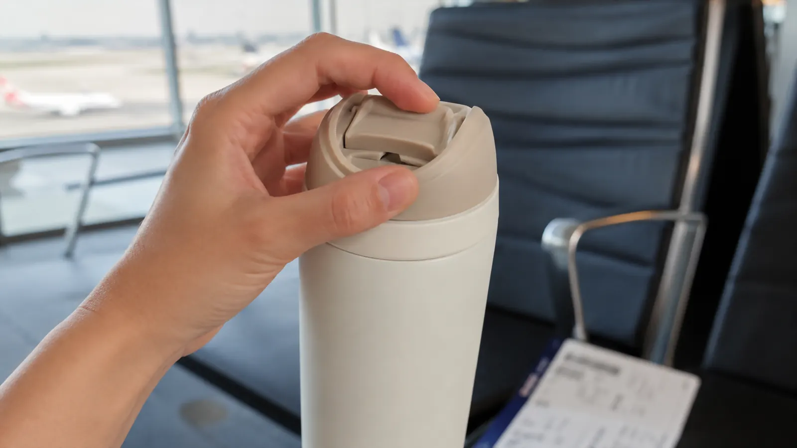 Close-up of the slider lid on the Owala SmoothSip being opened with one hand
