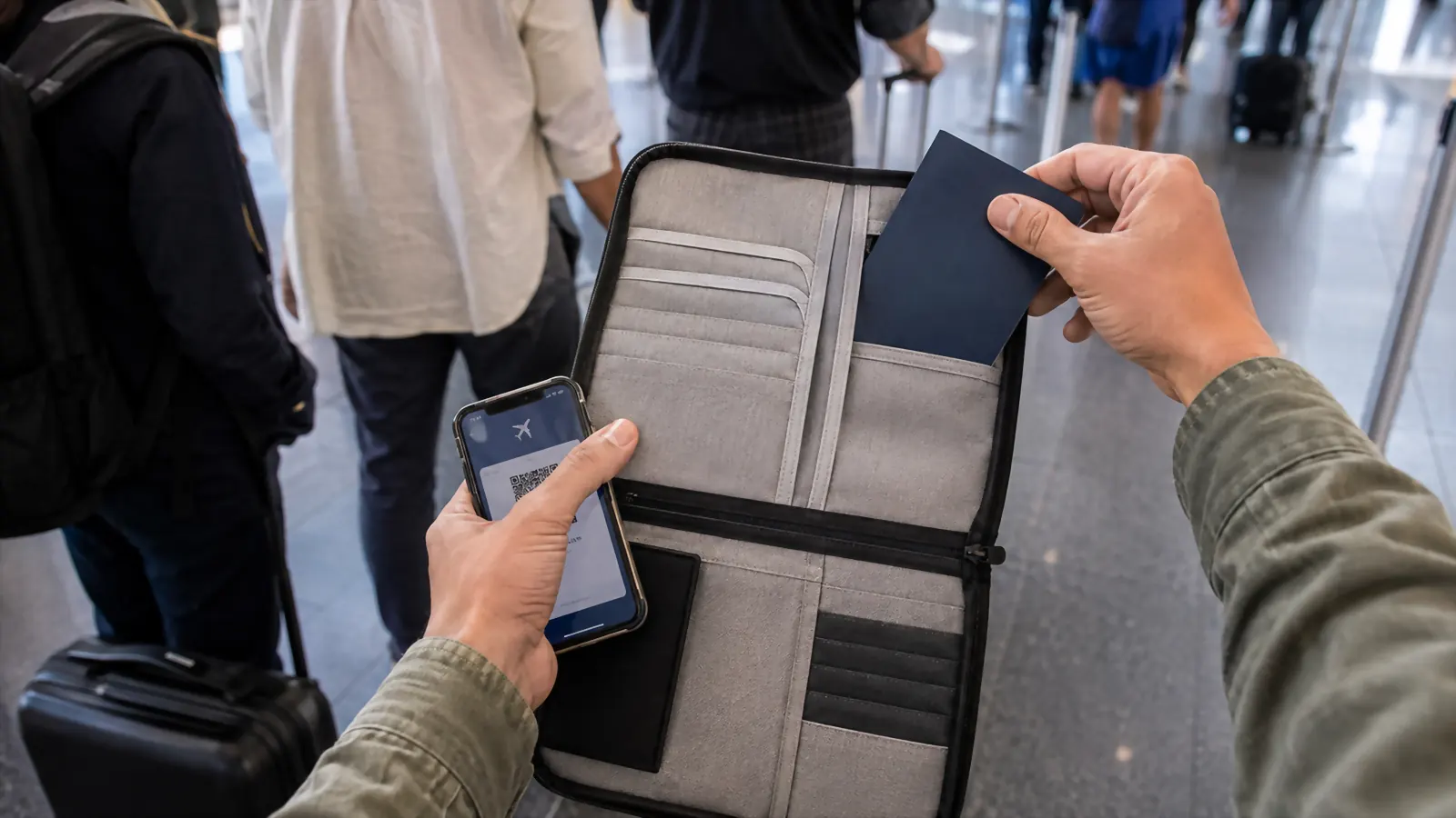 A hand pulling a passport out of the Valante gray document organizer while standing in a boarding line